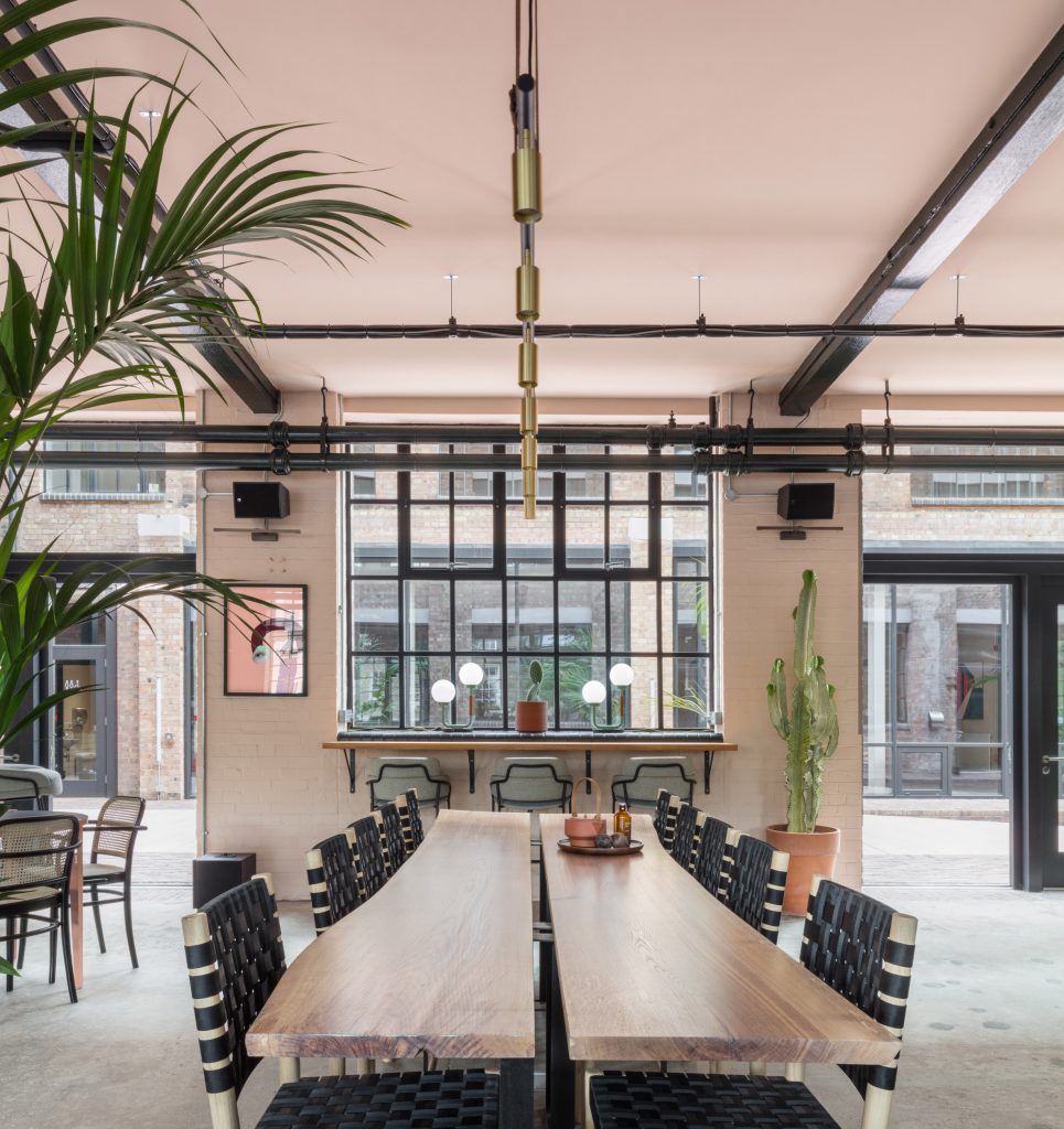 The smooth surface and soft-pink hue of a newly plastered wall provided the starting point for the design of communal spaces at this new creative hub in east London by local studio Sella Concept.