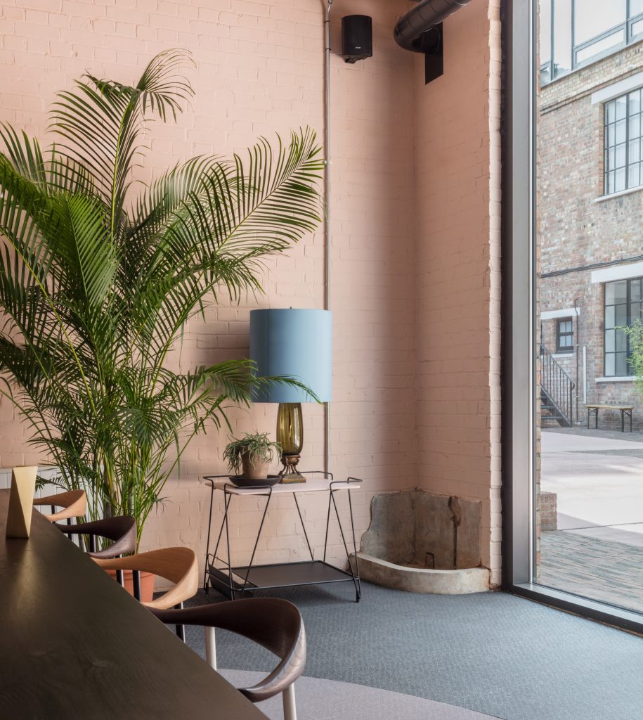 The smooth surface and soft-pink hue of a newly plastered wall provided the starting point for the design of communal spaces at this new creative hub in east London by local studio Sella Concept.