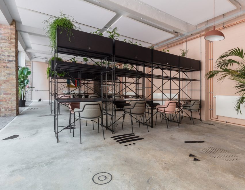 The smooth surface and soft-pink hue of a newly plastered wall provided the starting point for the design of communal spaces at this new creative hub in east London by local studio Sella Concept.