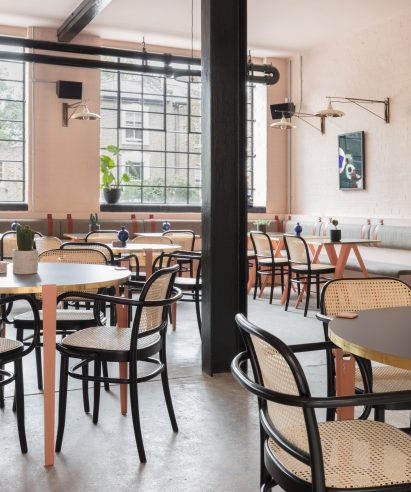 The smooth surface and soft-pink hue of a newly plastered wall provided the starting point for the design of communal spaces at this new creative hub in east London by local studio Sella Concept.