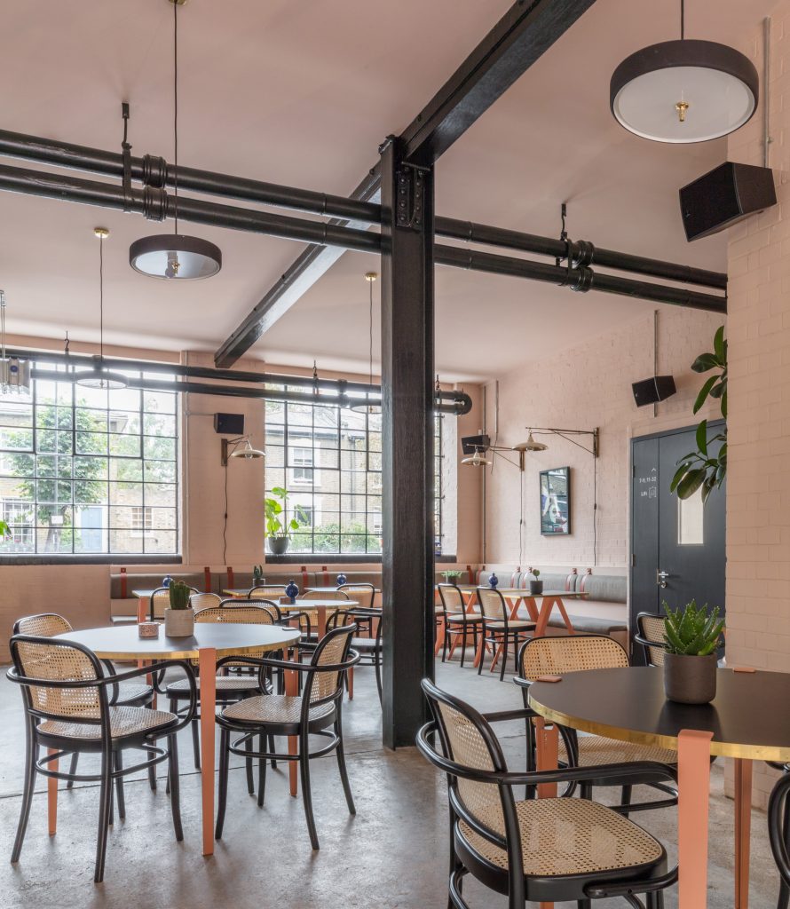 The smooth surface and soft-pink hue of a newly plastered wall provided the starting point for the design of communal spaces at this new creative hub in east London by local studio Sella Concept.