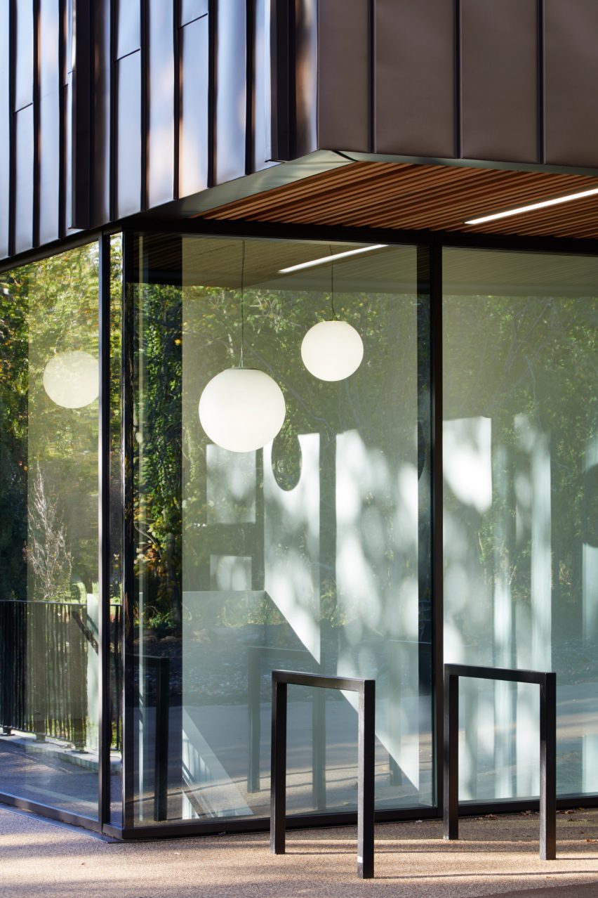 British firm Hawkins\Brown has completed a swimming-pool building at a school in Surrey, England, featuring an exposed timber frame that incorporates windows looking out onto the surrounding woodland.