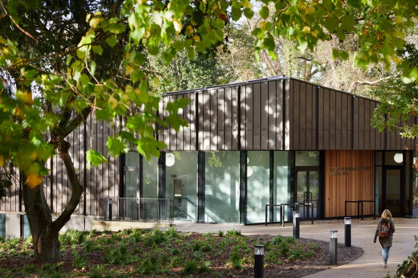 British firm Hawkins\Brown has completed a swimming-pool building at a school in Surrey, England, featuring an exposed timber frame that incorporates windows looking out onto the surrounding woodland.