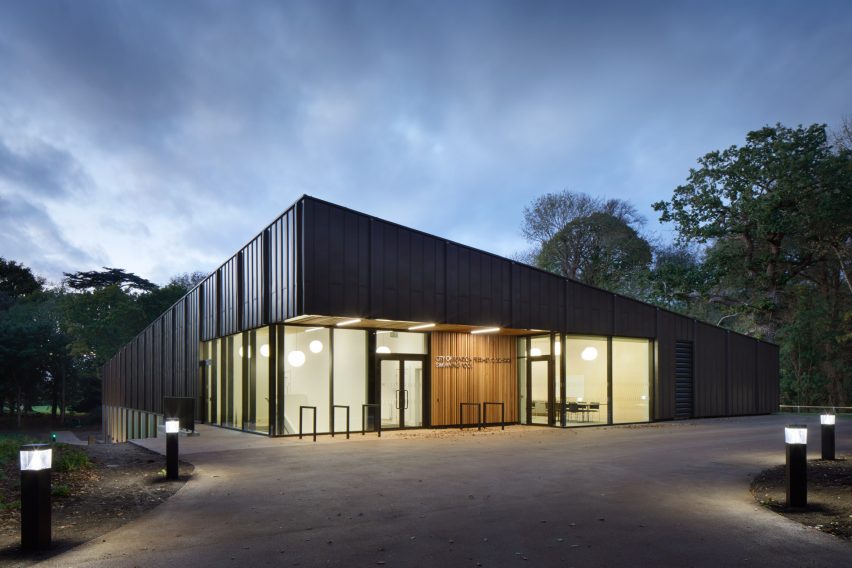 British firm Hawkins\Brown has completed a swimming-pool building at a school in Surrey, England, featuring an exposed timber frame that incorporates windows looking out onto the surrounding woodland.