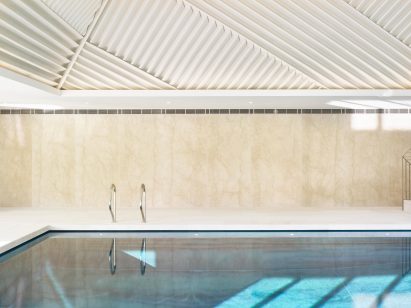 Rafael de Cárdenas adds pool house with stripy patterned ceiling and symmetrical slides to English country manor