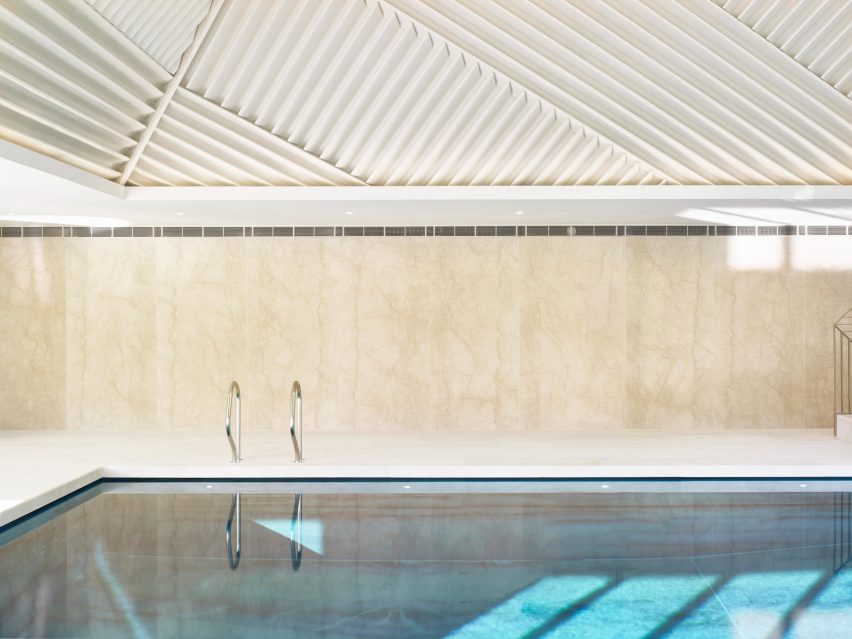 Rafael de Cárdenas adds pool house with stripy patterned ceiling and symmetrical slides to English country manor
