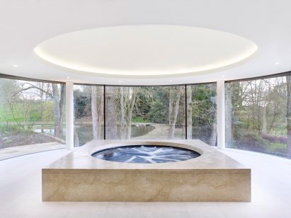 Rafael de Cárdenas adds pool house with stripy patterned ceiling and symmetrical slides to English country manor