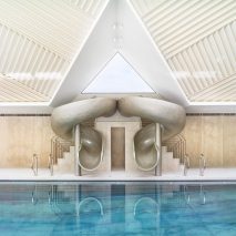 Rafael de Cárdenas adds pool house with stripy patterned ceiling and symmetrical slides to English country manor