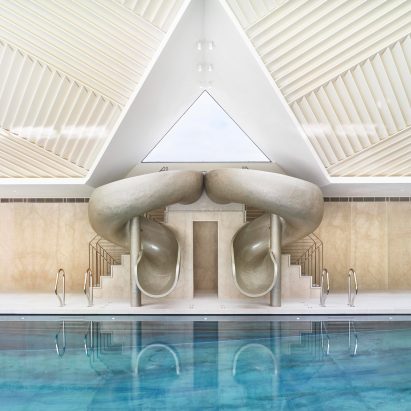 Rafael de Cárdenas adds pool house with stripy patterned ceiling and symmetrical slides to English country manor