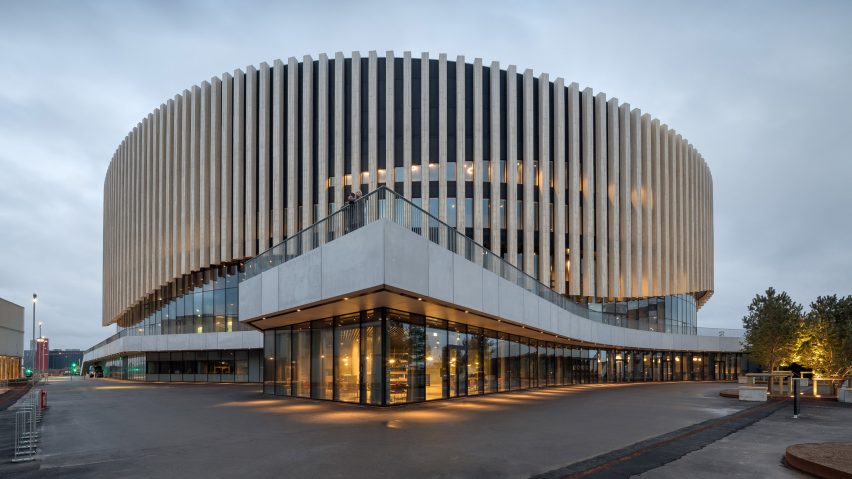 Copenhagen arena by 3XN has an undulating wooden facade that rises up above entrances