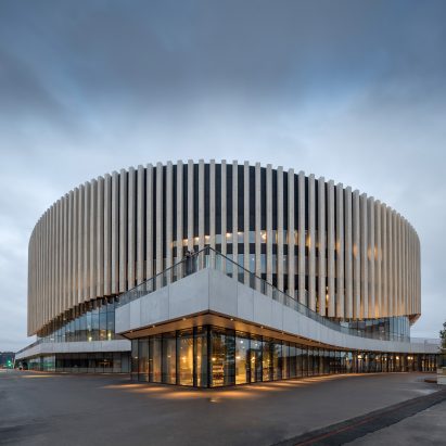 Copenhagen arena by 3XN has an undulating wooden facade that rises up above entrances