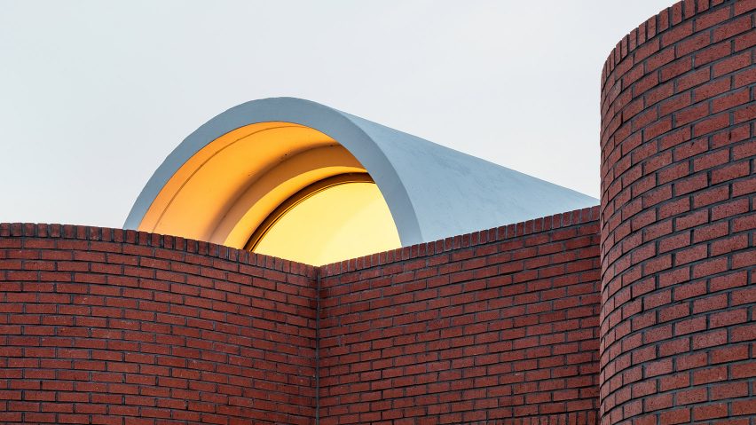 The Vault House by OBBA incorporates hidden gardens behind curving brick walls