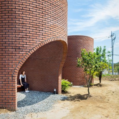 The Vault House by OBBA incorporates hidden gardens behind curving brick walls