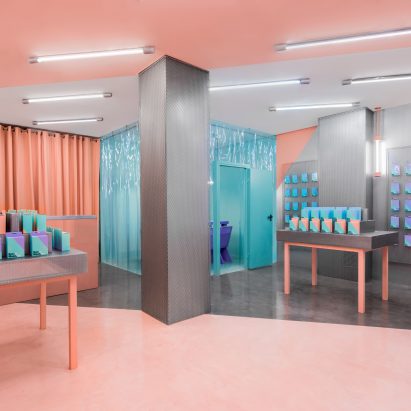 Masquespacio creates colour-clashing interior for phone-repair shop in Valencia