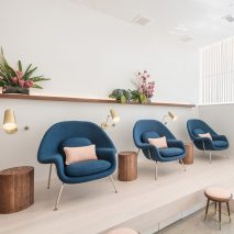 Content Architecture furnishes Paloma nail salon in Texas with comfy blue chairs and brass details