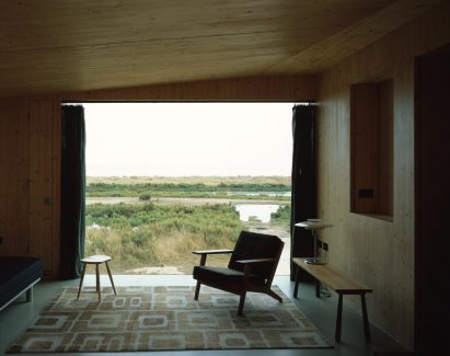 Living room with large window overlooking saltmarshes