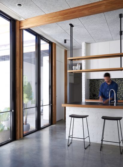 This single-storey house in Melbourne has been renovated by local studio Foomann to include exposed wooden beams that span the entirety of the property.