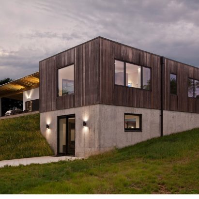 Haus wraps low-lying Indiana residence in thermally treated ash