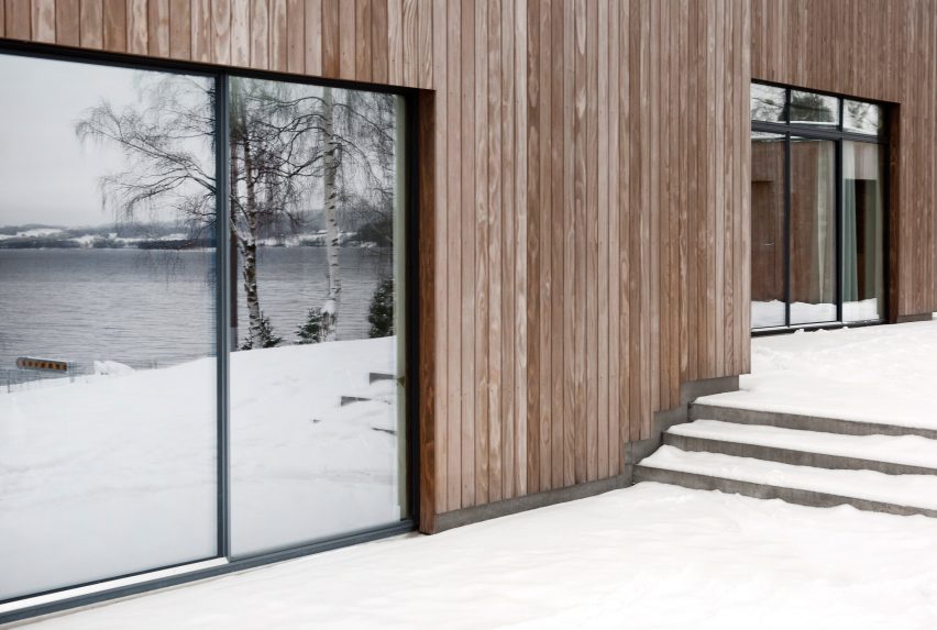 This family home by Danish practice Norm Architects is filled with cosy nooks and opening living areas with generous windows to give views out over picturesque woodland and a lake set around an hour's drive north of Oslo.