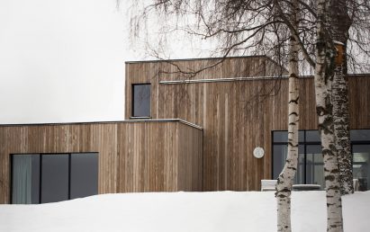This family home by Danish practice Norm Architects is filled with cosy nooks and opening living areas with generous windows to give views out over picturesque woodland and a lake set around an hour's drive north of Oslo.