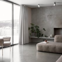 This family home by Danish practice Norm Architects is filled with cosy nooks and opening living areas with generous windows to give views out over picturesque woodland and a lake set around an hour's drive north of Oslo.