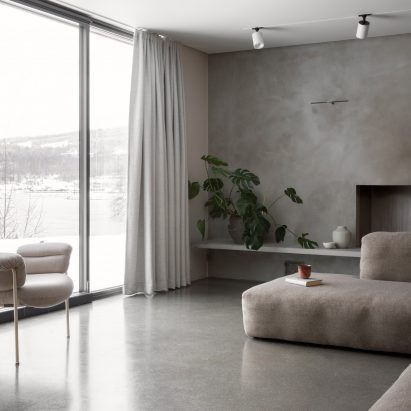 This family home by Danish practice Norm Architects is filled with cosy nooks and opening living areas with generous windows to give views out over picturesque woodland and a lake set around an hour's drive north of Oslo.
