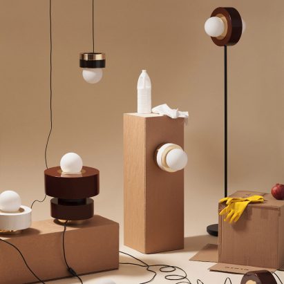 Haos combines layers of wood, ceramic and brass to create cylindrical lamps