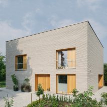 Oak-lined windows contrast pale brick facades at MFRMGR’s house in Warsaw