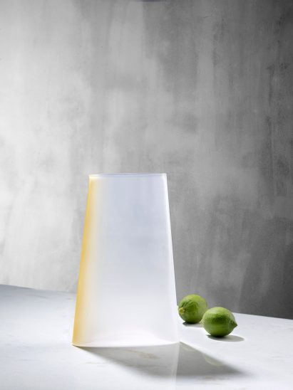 Nude has unveiled a new glassware collection, including a series of serving plates with accents of coloured pigment by Studio Formafantasma.