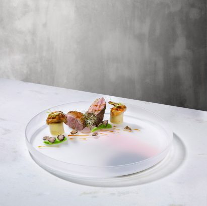 Nude has unveiled a new glassware collection, including a series of serving plates with accents of coloured pigment by Studio Formafantasma.