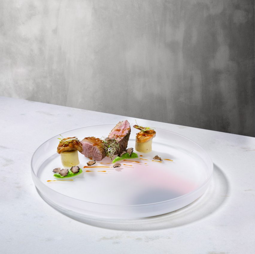 Nude has unveiled a new glassware collection, including a series of serving plates with accents of coloured pigment by Studio Formafantasma.