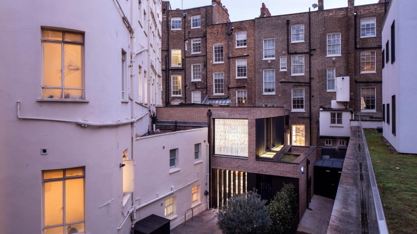 Pivoting louvres conceal windows set into brick facade of mews house by Belsize Architects
