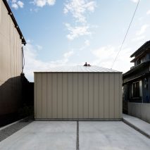 Deceptively industrial facade conceals bright contemporary home in Japan