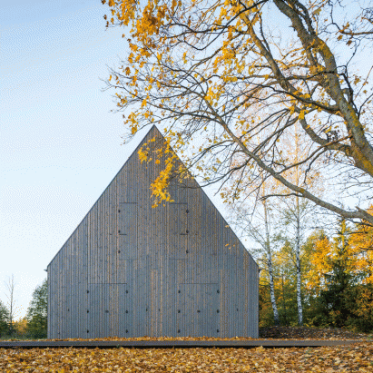 Aketuri Architektai conceals windows and doors behind large timber shutters at Lithuanian lakeside retreat