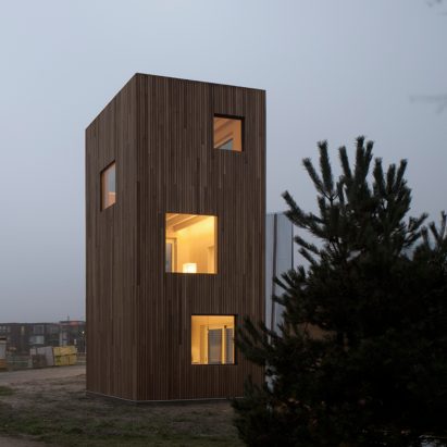 Sliding doors and built-in furniture save space inside skinny house by Ana Rocha Architecture