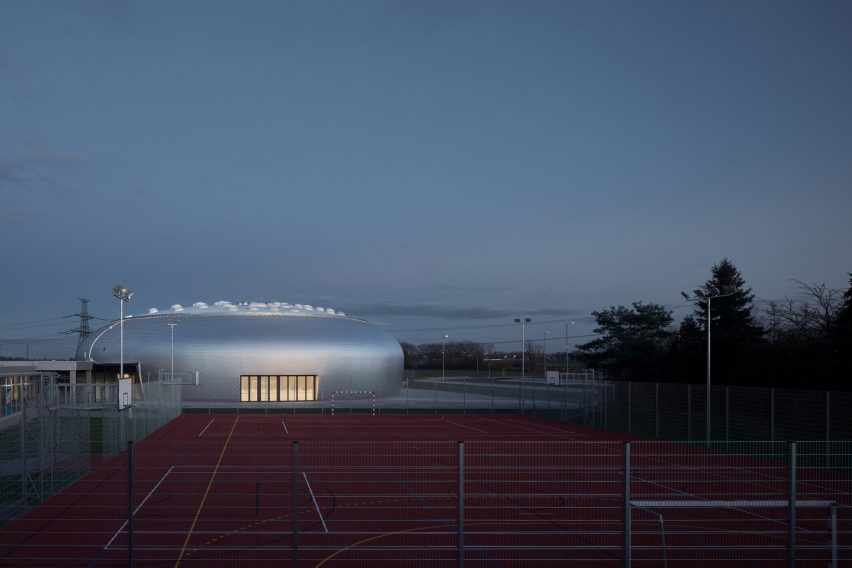 The sports hall designed by local architecture office Sporadical adjoins a recently modernised and extended primary school in the town of Dolní Břežany