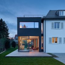 Holzer Architekten adds black extension to 1920s house in Stuttgart