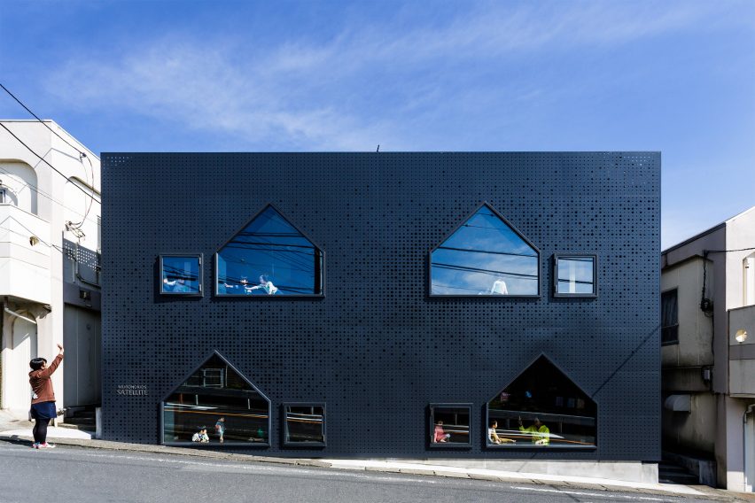 House-shaped windows puncture perforated-metal facades of Yokohama nursery