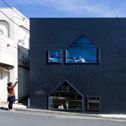House-shaped windows puncture perforated-metal facades of Yokohama nursery