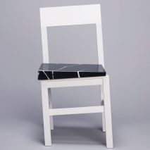 Snarkitecture’s Slip chair features wonky legs and a slanted seat