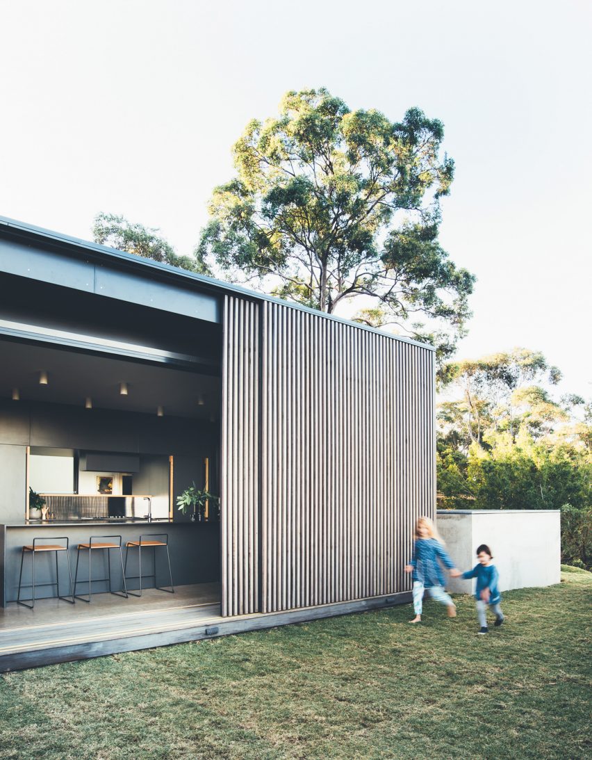 Sliding eucalyptus-wood screens wrap exterior of house on Australia's Sunshine Coast