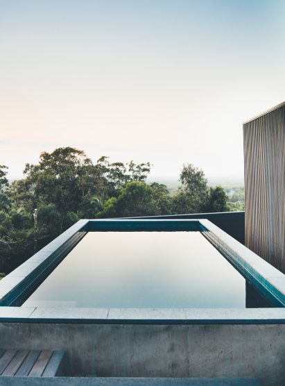 Sliding eucalyptus-wood screens wrap exterior of house on Australia's Sunshine Coast