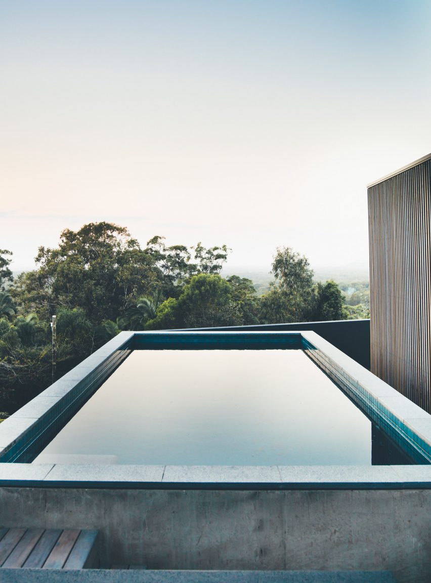 Sliding eucalyptus-wood screens wrap exterior of house on Australia's Sunshine Coast