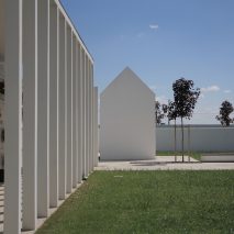 Gabled tombs sit within serene courtyards at Italian cemetery