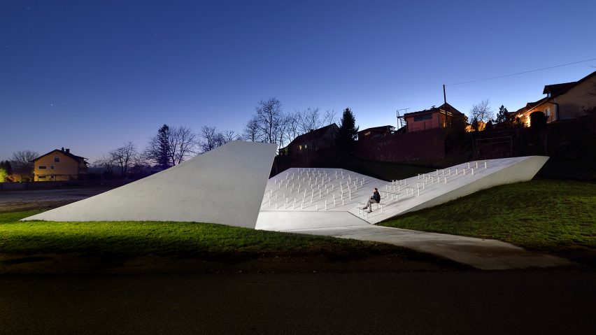 Sloping concrete volumes enclose social hub and chapel in a Slovenian village