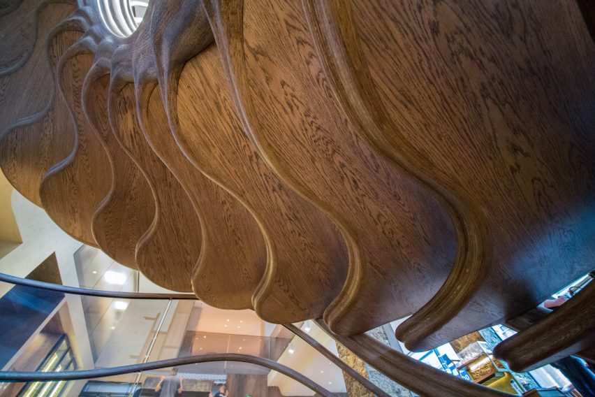 Atmos Studio's spiralling timber staircase features "leaf-like" stairs that emerge from a structural stem