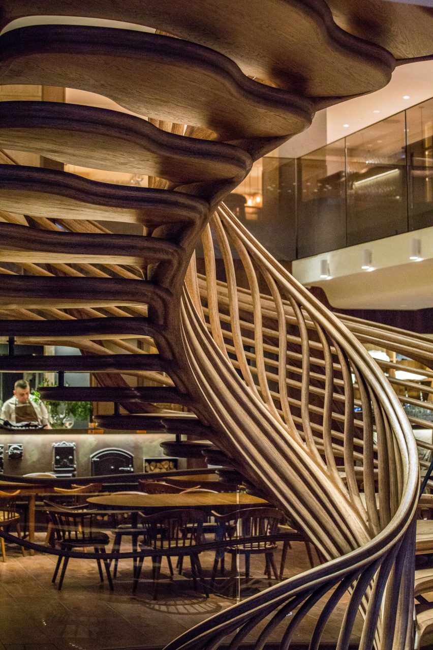 Atmos Studio's spiralling timber staircase features "leaf-like" stairs that emerge from a structural stem