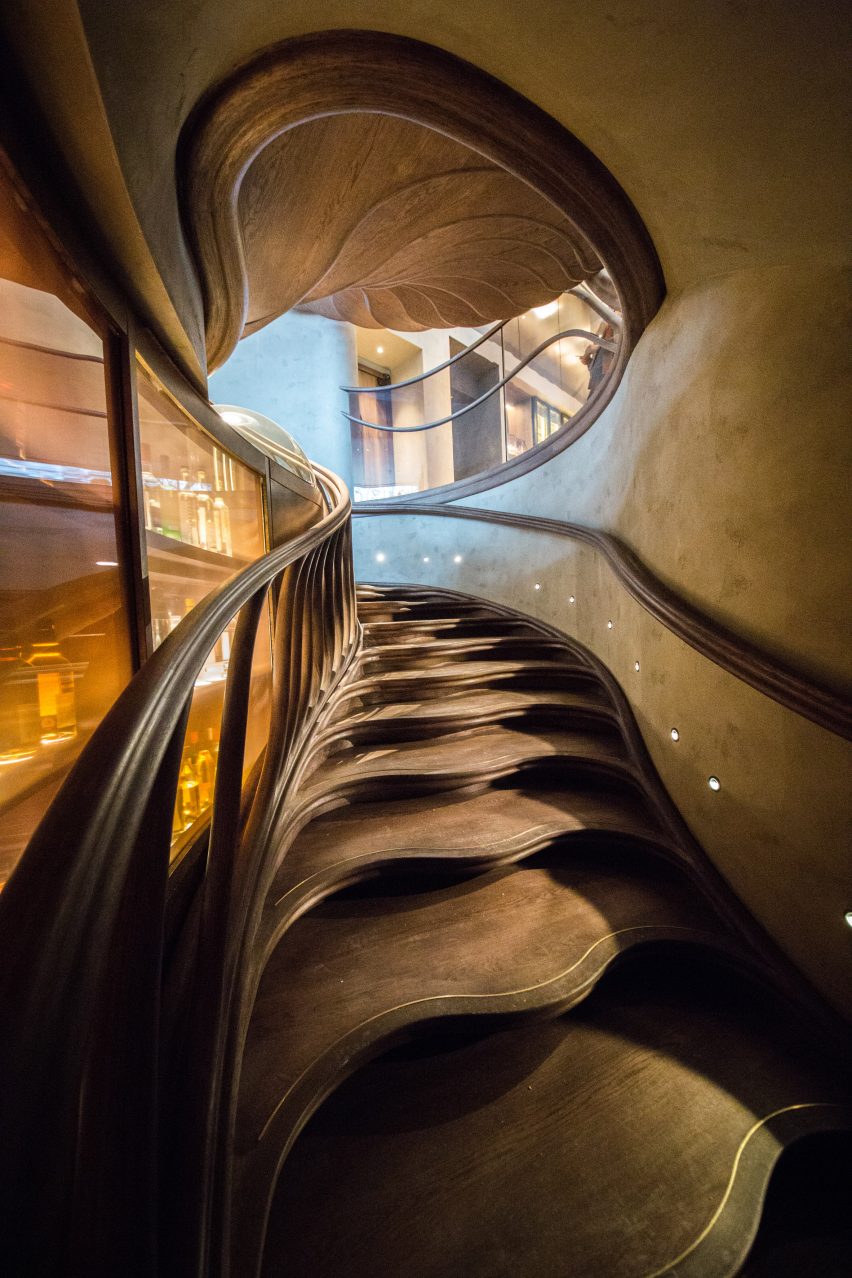 Atmos Studio's spiralling timber staircase features "leaf-like" stairs that emerge from a structural stem