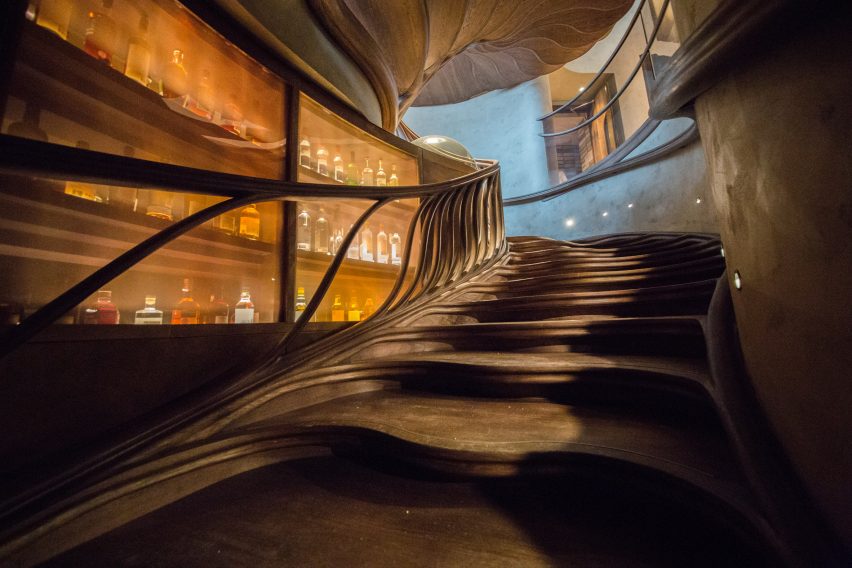 Atmos Studio's spiralling timber staircase features "leaf-like" stairs that emerge from a structural stem
