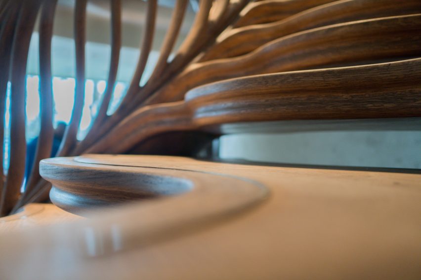 Atmos Studio's spiralling timber staircase features "leaf-like" stairs that emerge from a structural stem